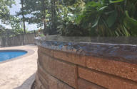 Swimming pool and concrete retaining wall we built in Elm Springs Arkansas